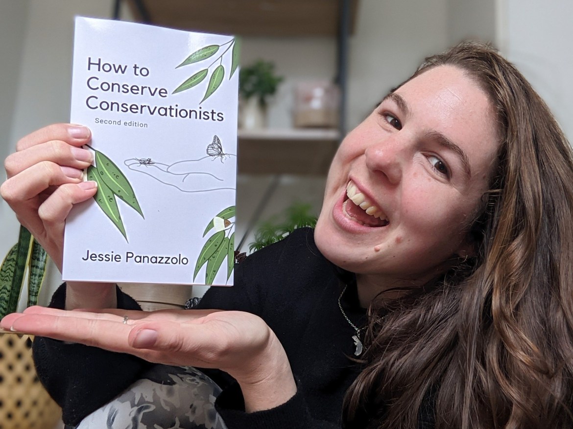 Jess holds How to Conserve Conservationists book